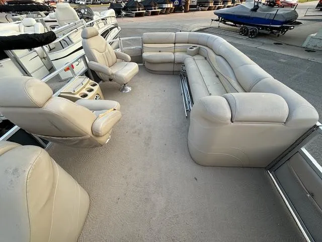 Slide: The Image of 2009 Bennington 2575RLi pontoon boat with beige seating and spacious layout. - 3