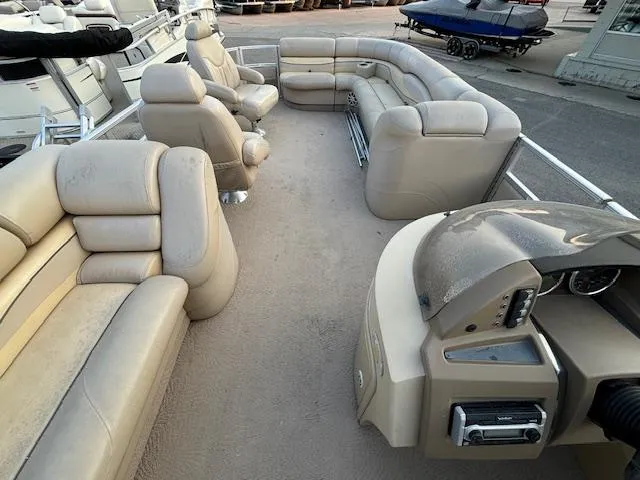 Slide: The Image of 2009 Bennington 2575RLi pontoon boat with spacious beige seating and helm station. - 4