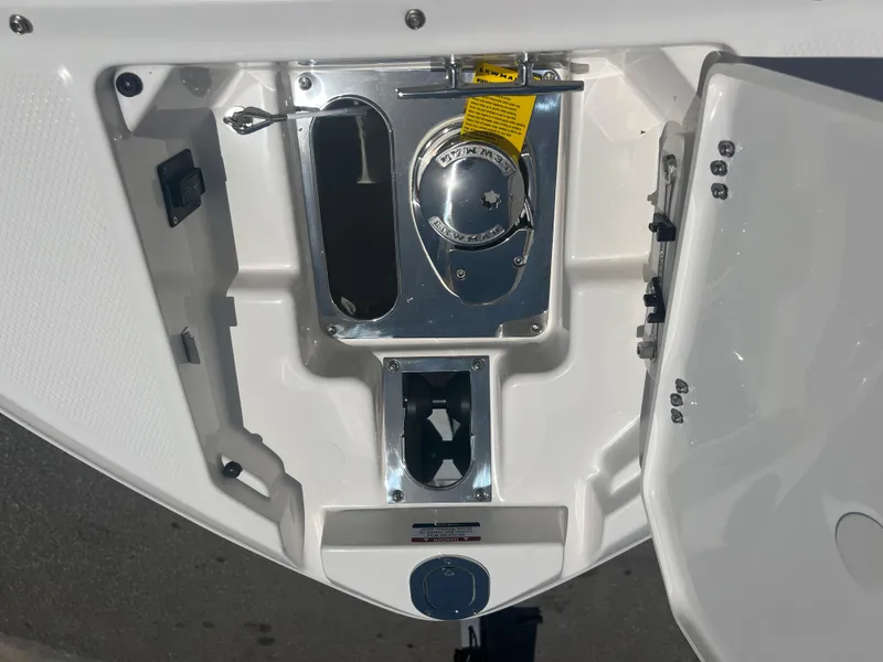 Slide: The Image of 2024 Chaparral 270 OSX boat anchor compartment with stainless steel fittings. - 13