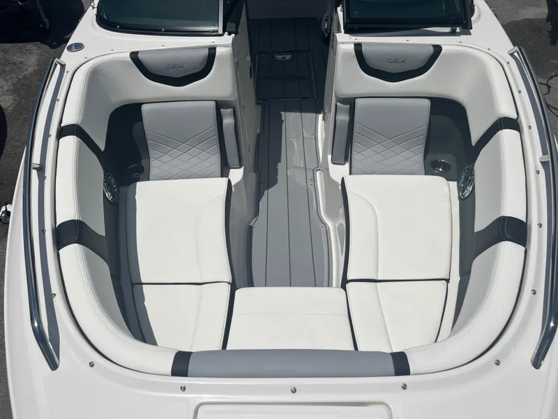 Slide: The Image of 2024 Chaparral 270 OSX boat interior with white and gray seating. - 14