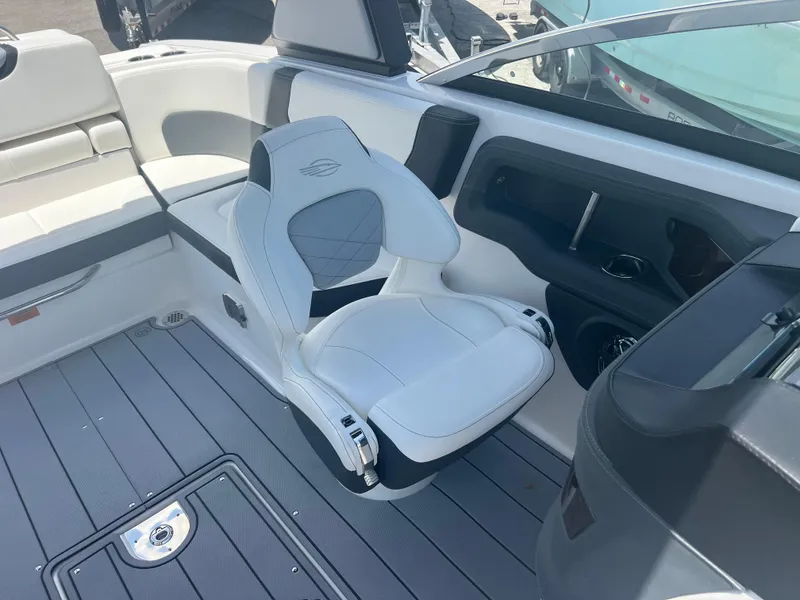Slide: The Image of 2024 Chaparral 270 OSX boat interior with white seating and modern design. - 17