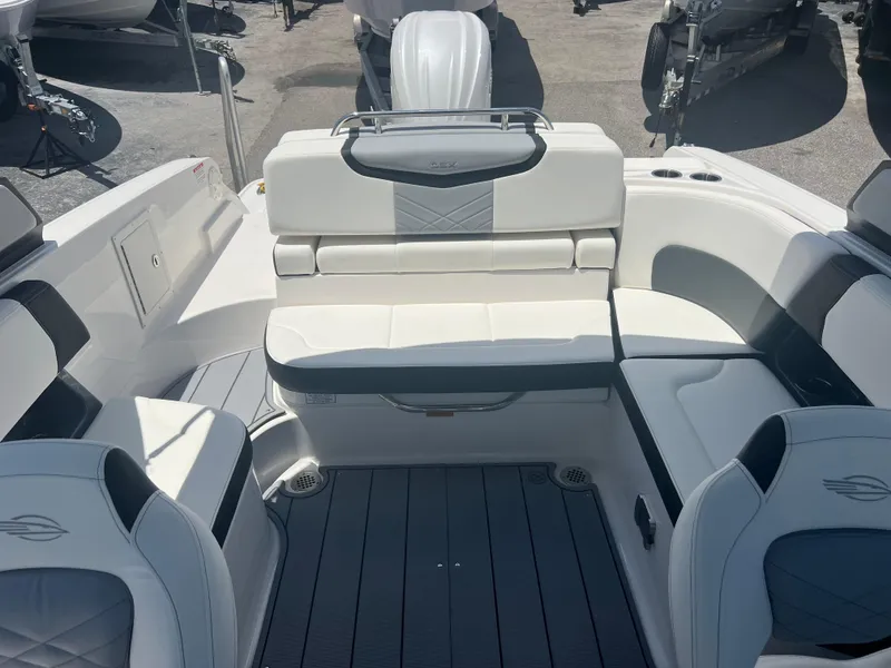 Slide: The Image of 2024 Chaparral 270 OSX boat interior with white seating and modern design. - 18
