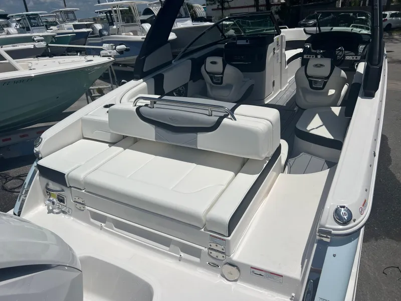 Slide: The Image of 2024 Chaparral 270 OSX boat with white seating and modern cockpit design. - 4