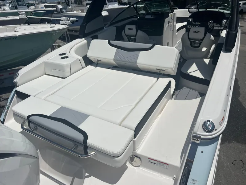 Slide: The Image of 2024 Chaparral 270 OSX boat interior with white seating and modern design. - 5