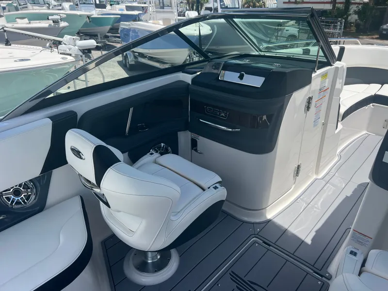 Slide: The Image of 2024 Chaparral 270 OSX boat interior with captain's chair and dashboard. - 7
