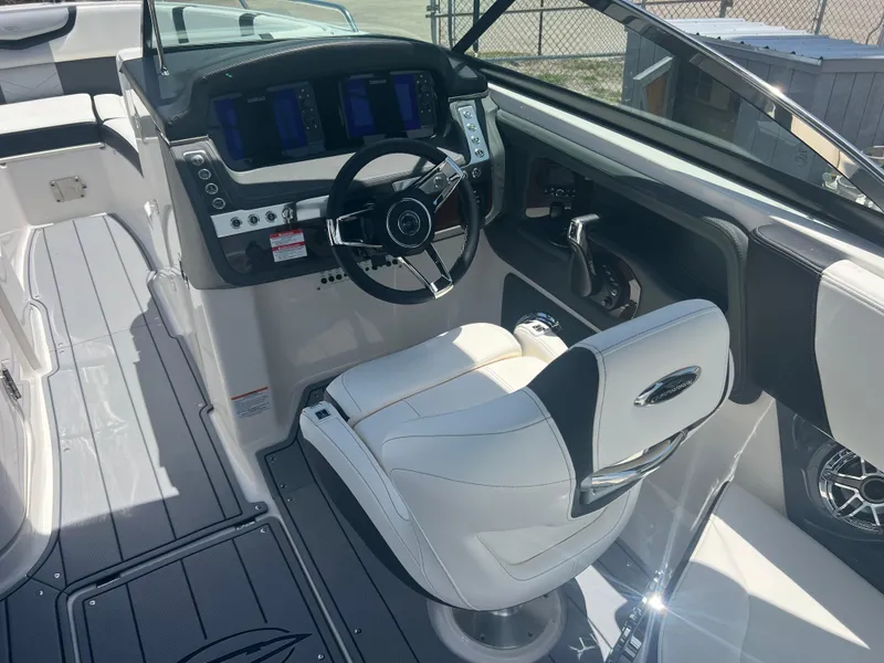 Slide: The Image of 2024 Chaparral 270 OSX boat cockpit with modern steering and controls. - 9