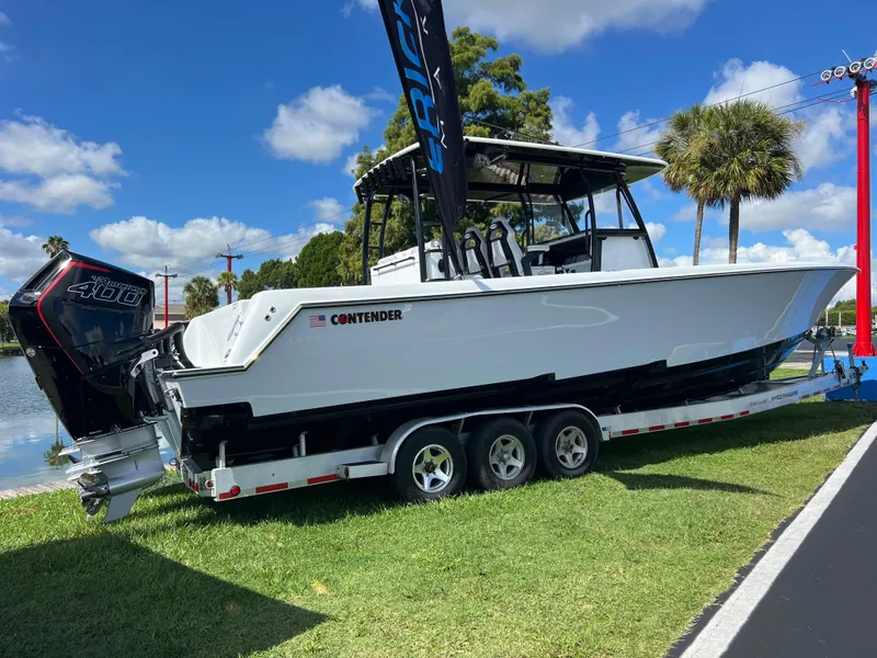 Slide: The Image of 2024 Contender 39 ST Center Console boat on a trailer, displayed outdoors. - 2