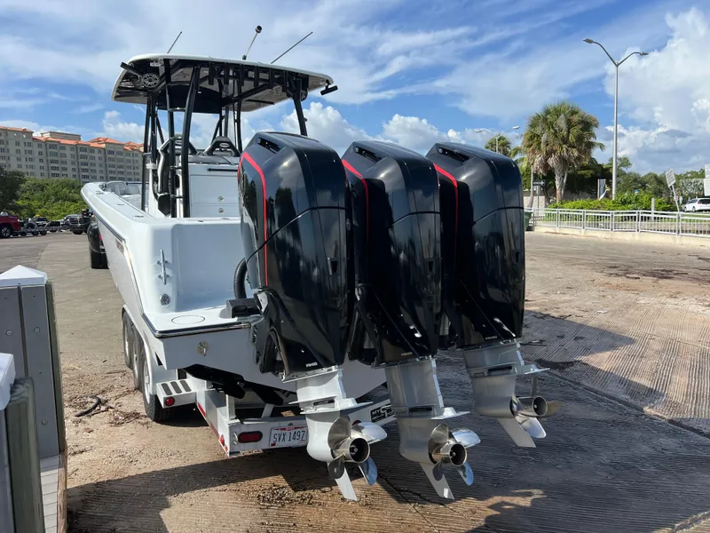 Slide: The Image of 2024 Contender 39 ST Center Console boat with triple outboard engines. - 23