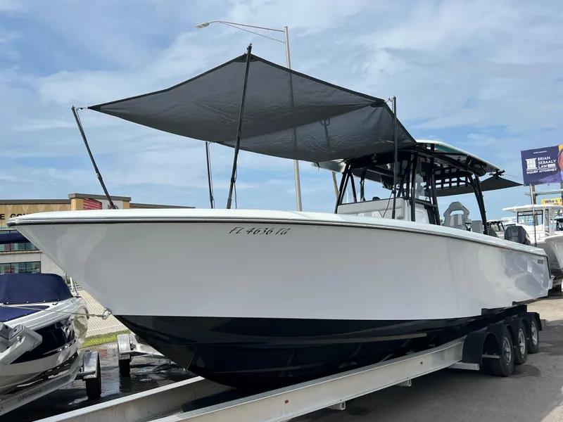 Slide: The Image of 2024 Contender 39 ST Center Console boat on trailer, featuring a sunshade canopy. - 24