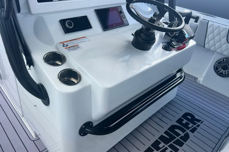 Slide: The Image of 2024 Contender 39 ST boat console with steering wheel and cup holders. - 27
