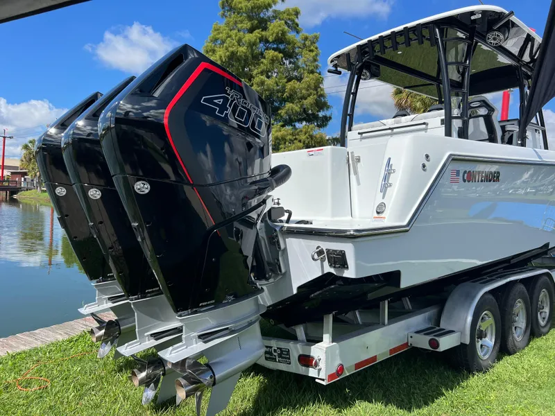 Slide: The Image of 2024 Contender 39 ST Center Console boat with triple 400 HP engines on trailer. - 3