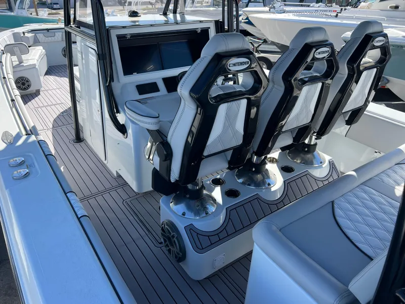 Slide: The Image of 2024 Contender 39 ST Center Console boat interior with modern seating and control panel. - 5