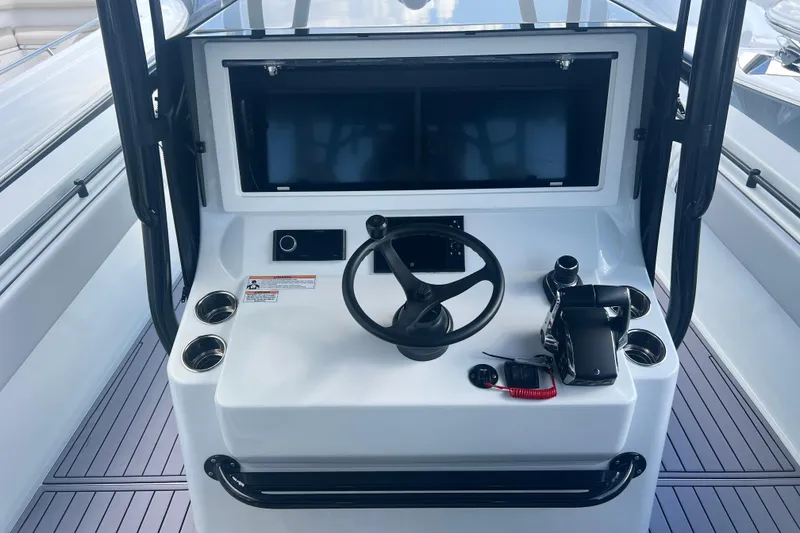 Slide: The Image of 2024 Contender 39 ST boat helm with steering wheel and control panel. - 7
