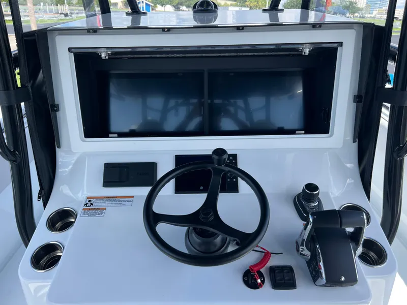 Slide: The Image of 2024 Contender 39 ST Center Console helm with steering wheel and dual displays. - 8