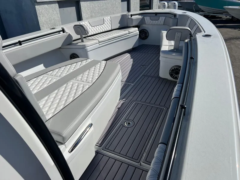 Slide: The Image of 2024 Contender 39 ST Center Console boat interior with cushioned seating and sleek design. - 9