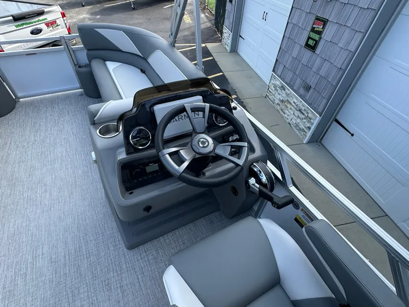 Slide: The Image of 2025 Tahoe Pontoon 2385 Sport 85 Quad Lounger Tri Toon steering console and seating area. - 20