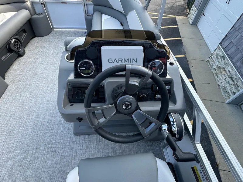 Slide: The Image of 2025 Tahoe Pontoon 2385 Sport 85 Quad Lounger Tri Toon helm with Garmin navigation system. - 21