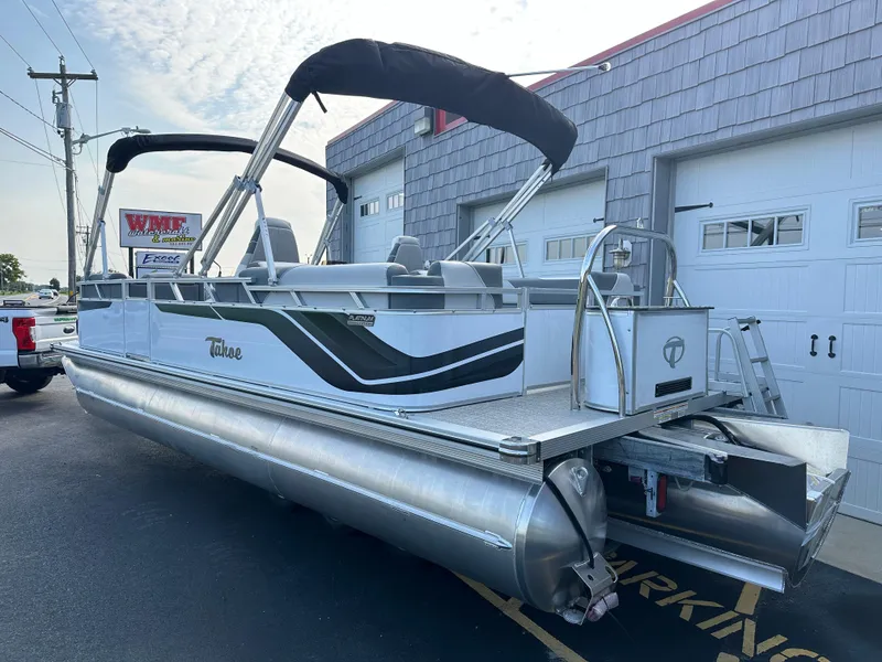 Slide: The Image of 2025 Tahoe Pontoon 2385 Sport 85 Quad Lounger Tri Toon Sport Performance boat in parking lot. - 5