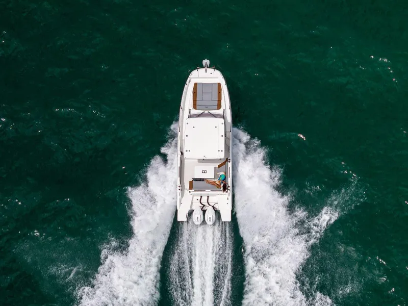 Slide: The Image of Aerial view of 2025 Beneteau Flyer 9 SUNdeck cruising on open water. - 1