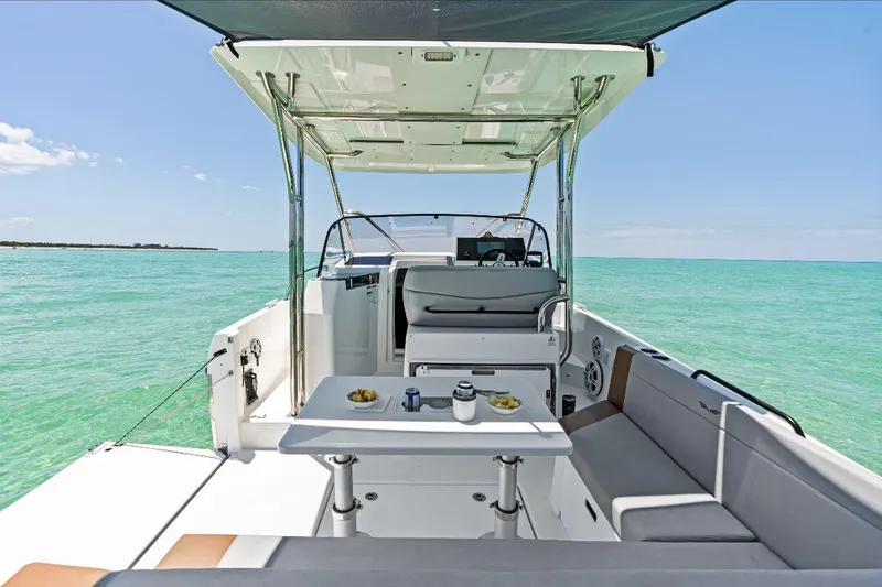 Slide: The Image of 2025 Beneteau Flyer 9 SUNdeck, luxurious boat interior with seating, table, and ocean view. - 3