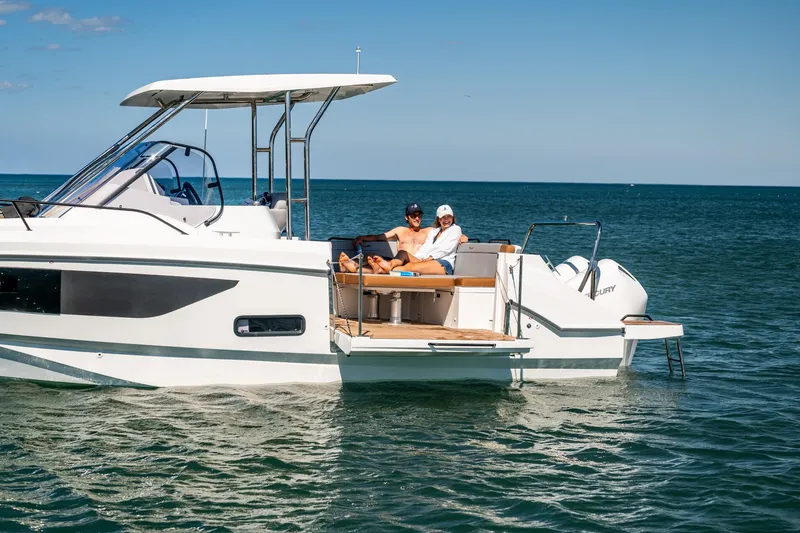 Slide: The Image of 2025 Beneteau Flyer 9 SUNdeck cruising on open water with passengers relaxing. - 9