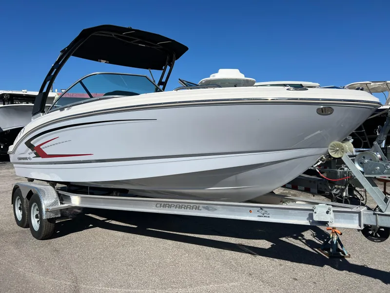 The Image of 2024 Chaparral 21 SSi OB boat on trailer, sleek design, white exterior. - 1