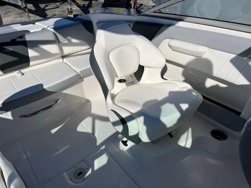 Slide: The Image of 2024 Chaparral 21 SSi OB boat interior with white seating and modern design. - 16