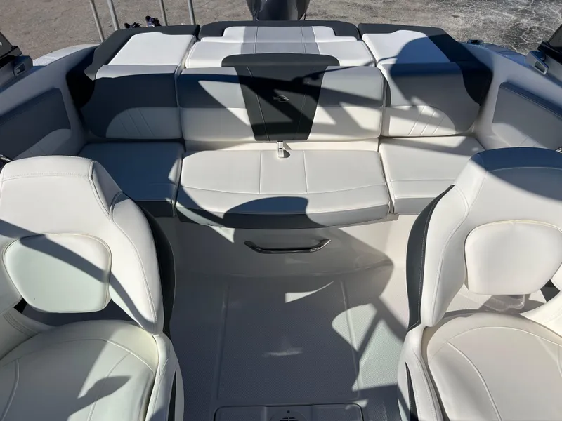Slide: The Image of 2024 Chaparral 21 SSi OB boat interior with white and gray seating. - 17