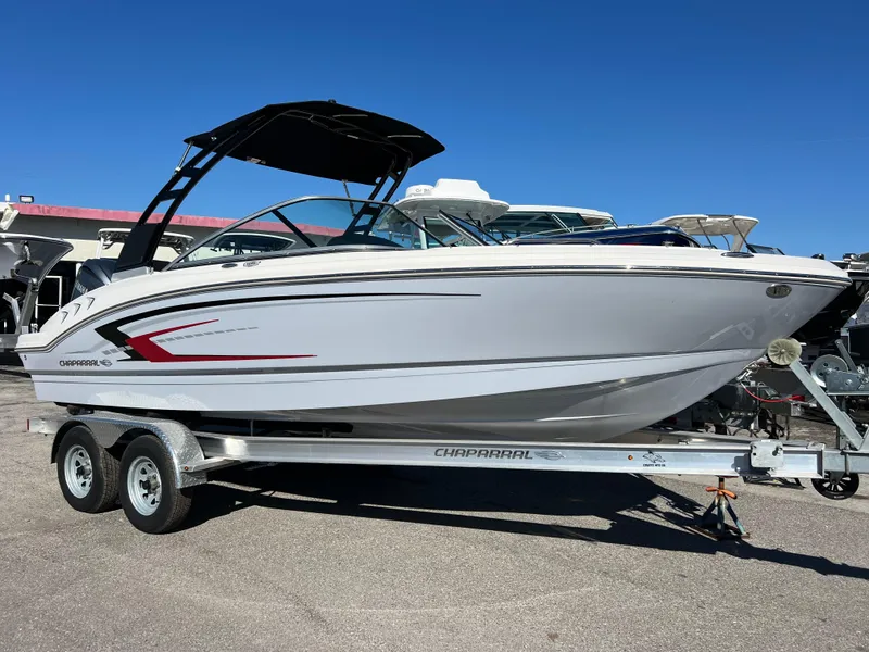 Slide: The Image of 2024 Chaparral 21 SSi OB boat on trailer, sleek design, white exterior. - 2