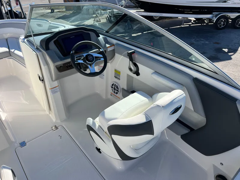 Slide: The Image of 2024 Chaparral 21 SSi OB boat interior with steering wheel and captain's seat. - 9