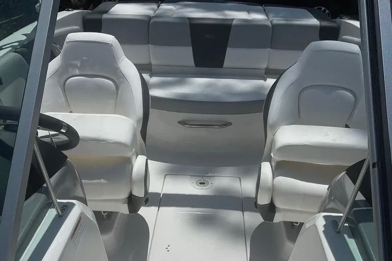 Slide: The Image of 2024 Chaparral 19 SSi OB boat interior with white seating and steering wheel. - 11