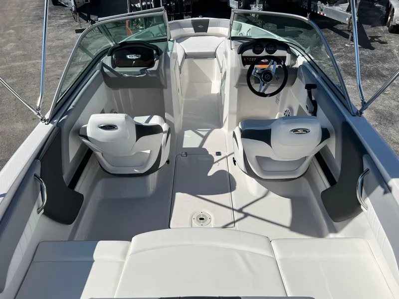 Slide: The Image of 2024 Chaparral 19 SSi OB boat interior with dual seating and steering wheel. - 4