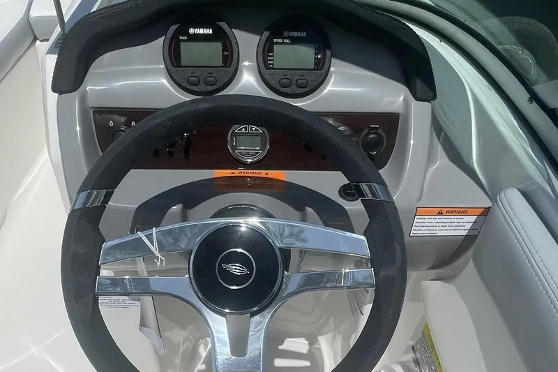 Slide: The Image of 2024 Chaparral 19 SSi OB boat dashboard with steering wheel and Yamaha gauges. - 6