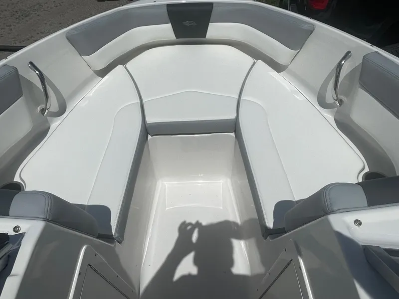 Slide: The Image of 2024 Chaparral 19 SSi OB boat interior with white and gray seating. - 8