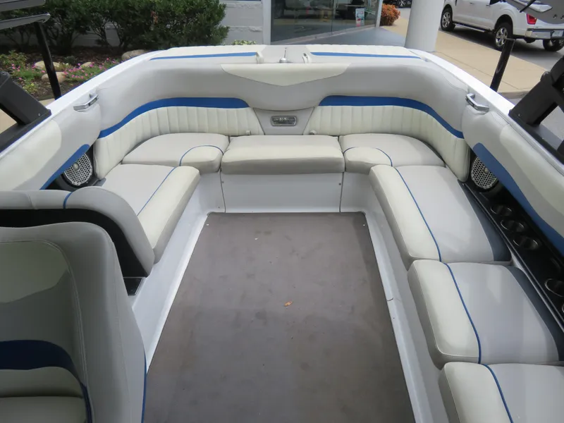 Slide: The Image of 2015 Malibu Wakesetter 24 MXZ boat interior with white and blue seating. - 3