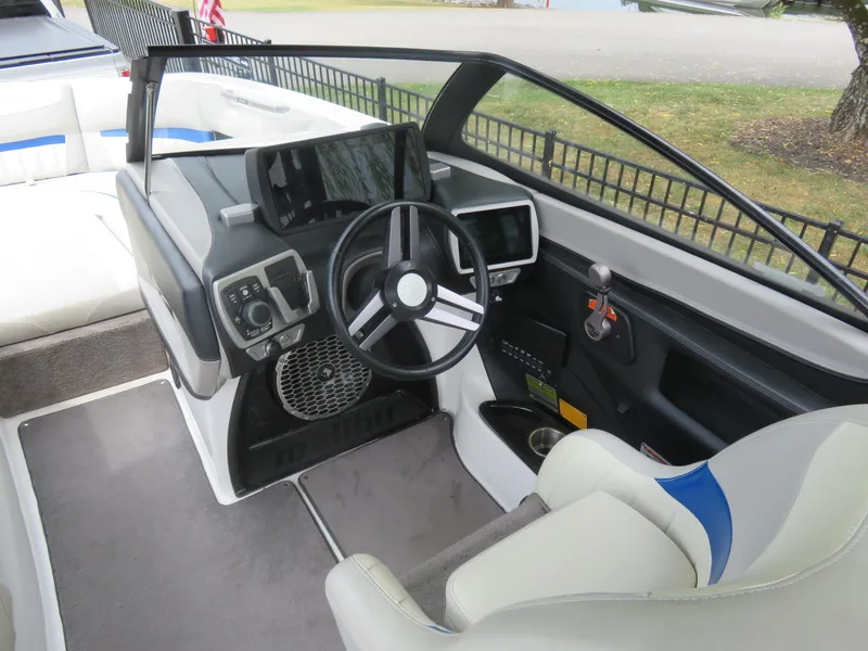Slide: The Image of 2015 Malibu Wakesetter 24 MXZ boat cockpit with steering wheel and control panel. - 4