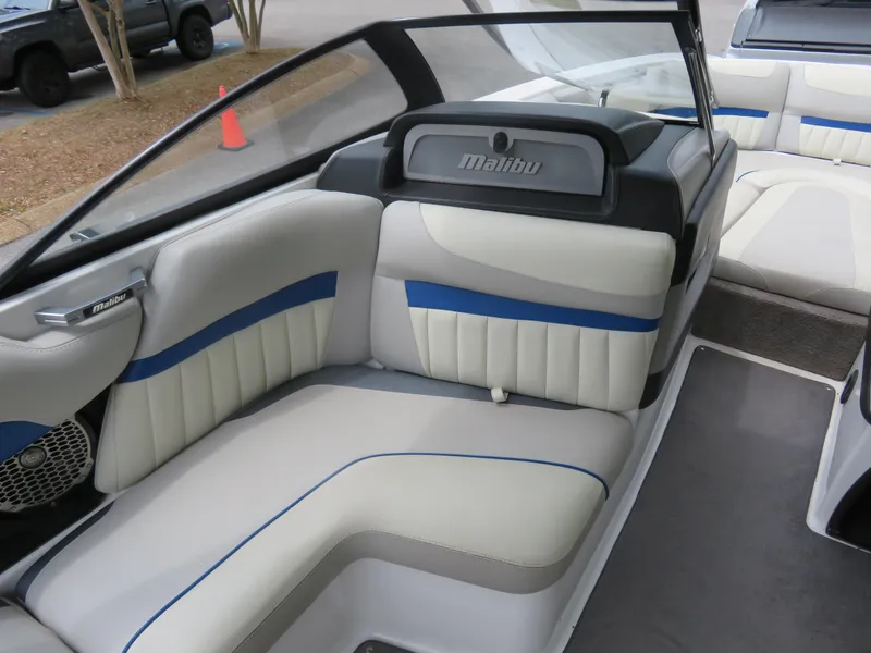 Slide: The Image of 2015 Malibu Wakesetter 24 MXZ interior with white and blue seating. - 5