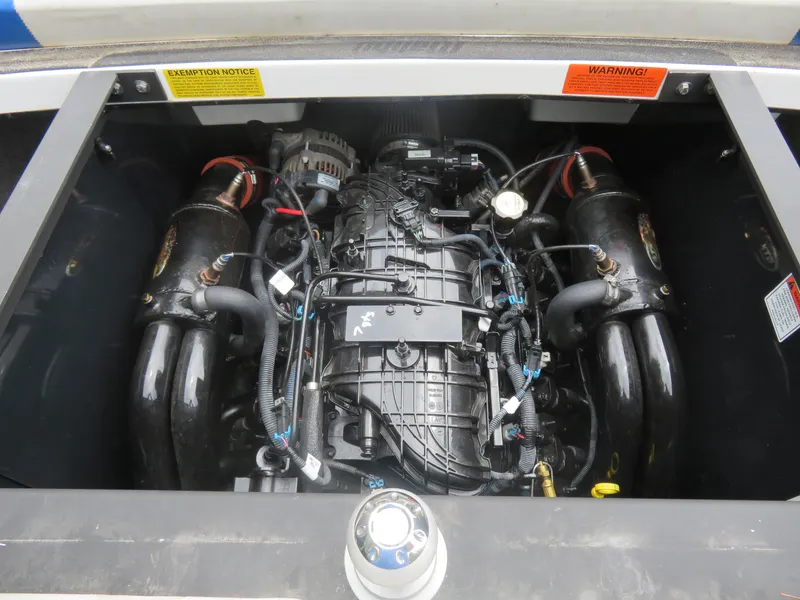 Slide: The Image of 2015 Malibu Wakesetter 24 MXZ engine compartment with visible components. - 7