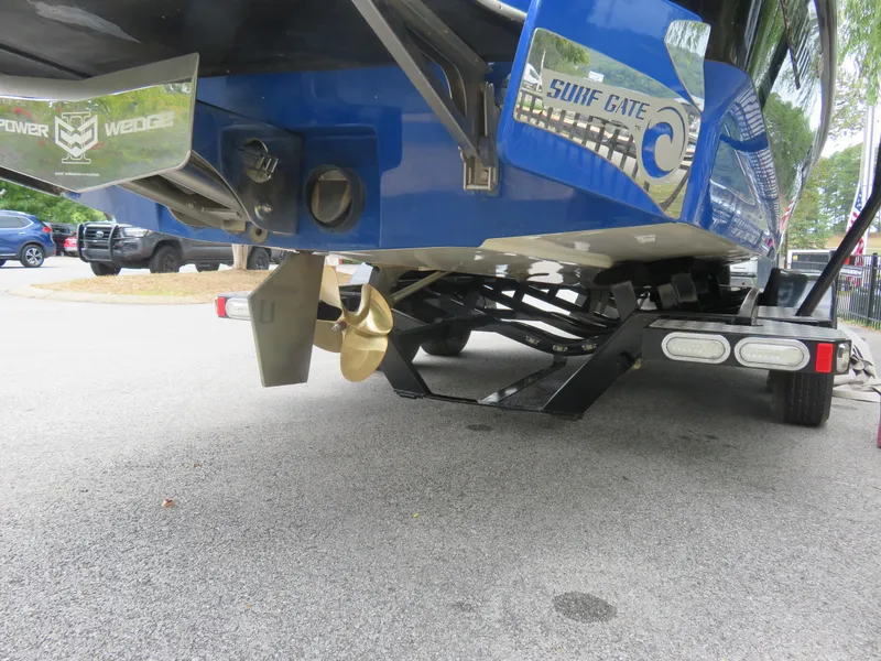 Slide: The Image of 2015 Malibu Wakesetter 24 MXZ boat on trailer, showing propeller and Surf Gate system. - 8