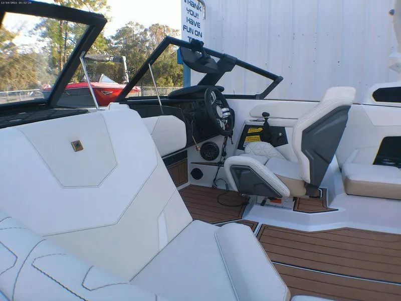Slide: The Image of 2023 Nautique Super Air GS20 interior with white seating and modern dashboard design. - 3