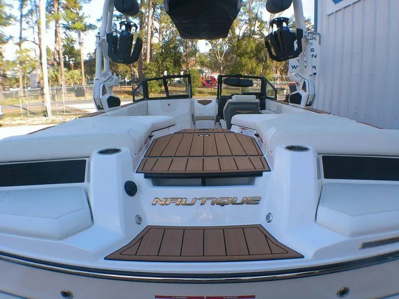 Slide: The Image of 2023 Nautique Super Air GS20 boat with teak deck, white interior, and sleek design. - 7
