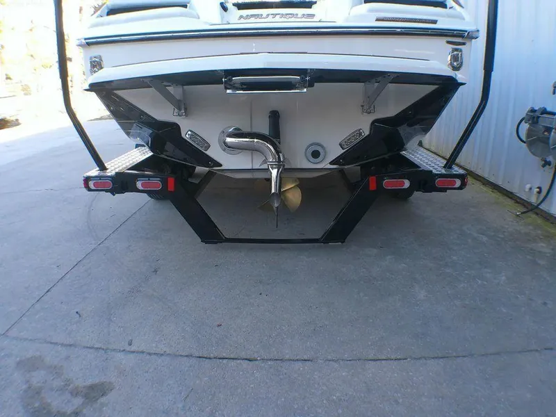 Slide: The Image of 2023 Nautique Super Air GS20 boat rear view with propeller and exhaust system. - 9