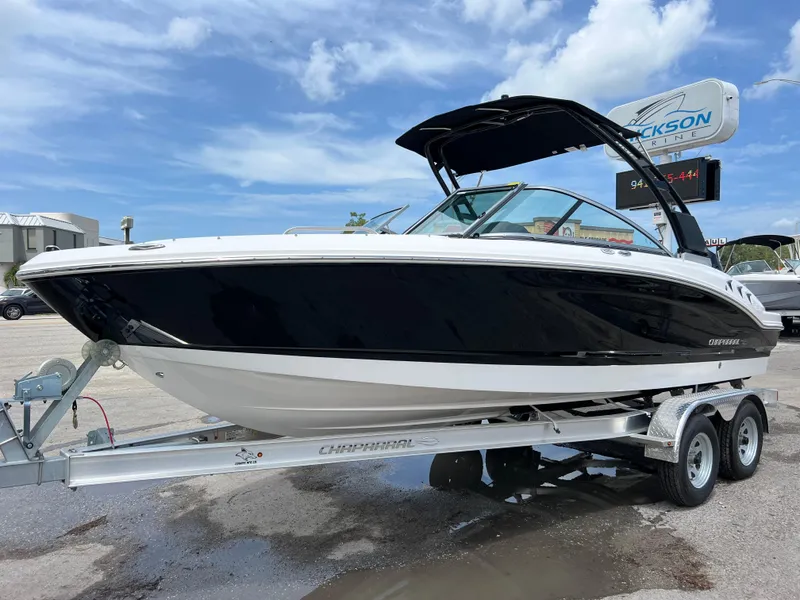 The Image of 2024 Chaparral 21 SSi OB boat on a trailer under a blue sky. - 0