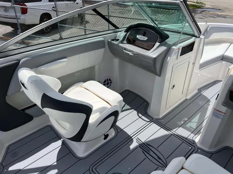 Slide: The Image of 2024 Chaparral 21 SSi OB boat interior with captain's chair and dashboard. - 10
