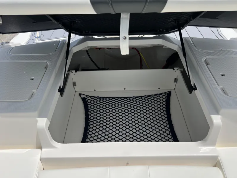 Slide: The Image of 2024 Chaparral 21 SSi OB boat storage compartment with netting. - 17