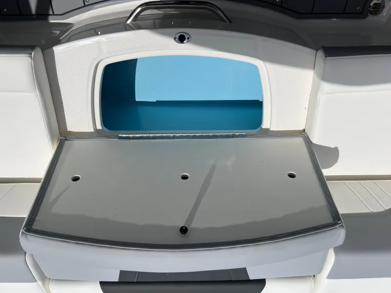 Slide: The Image of 2024 Chaparral 21 SSi OB boat storage compartment with open hatch. - 18