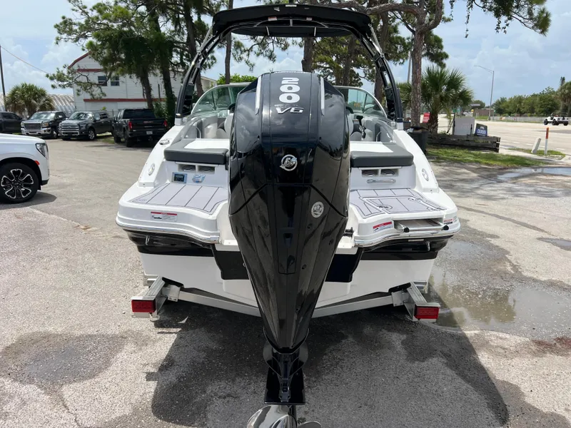 Slide: The Image of 2024 Chaparral 21 SSi OB boat with a powerful outboard motor, rear view. - 3