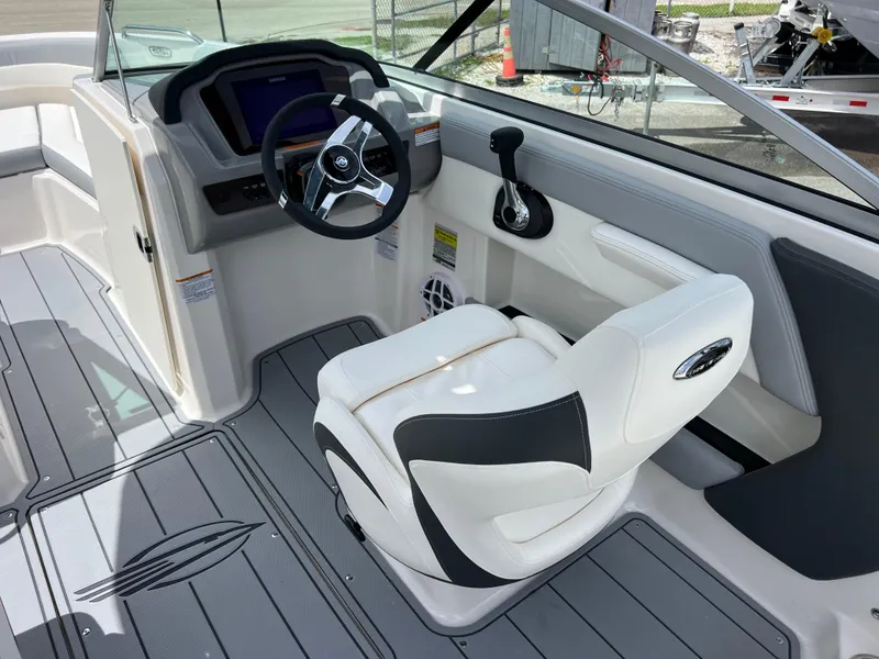 Slide: The Image of 2024 Chaparral 21 SSi OB boat interior with steering wheel and captain's chair. - 9
