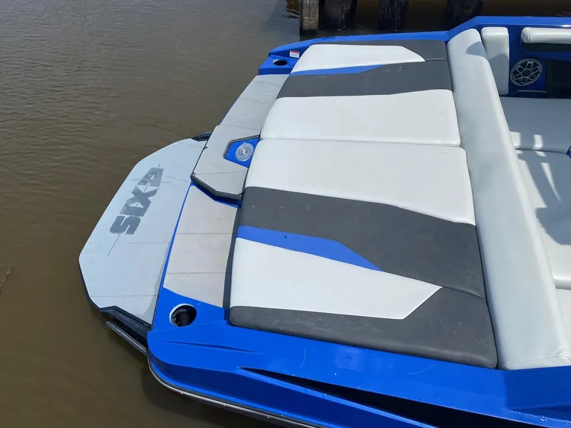 Slide: The Image of 2022 Axis T220 boat with blue and white seating on the water. - 3