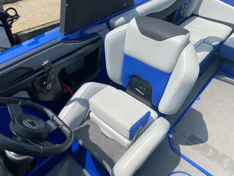 Slide: The Image of 2022 Axis T220 boat interior with blue and gray seating and steering wheel. - 6